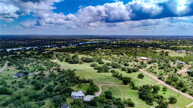 an aerial view of a house with a yard