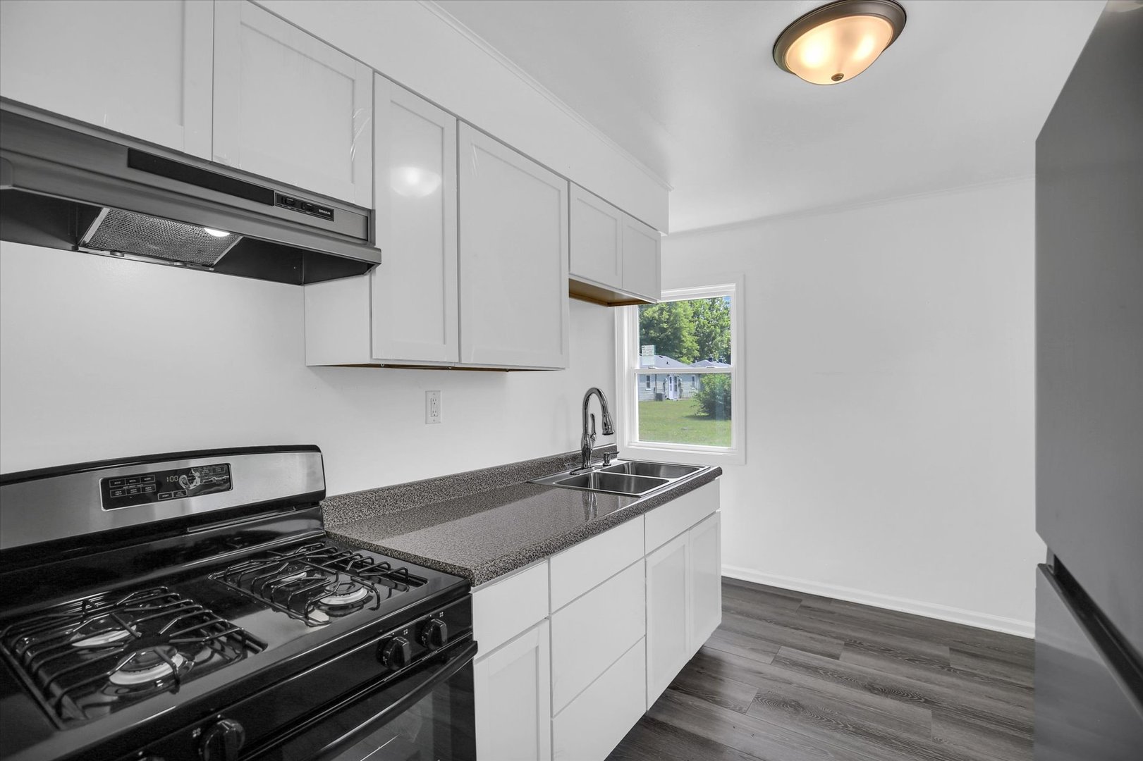804 Juniper Drive Rantoul, IL 61866 - Photo 11 of 24 a kitchen with a stove and a microwave