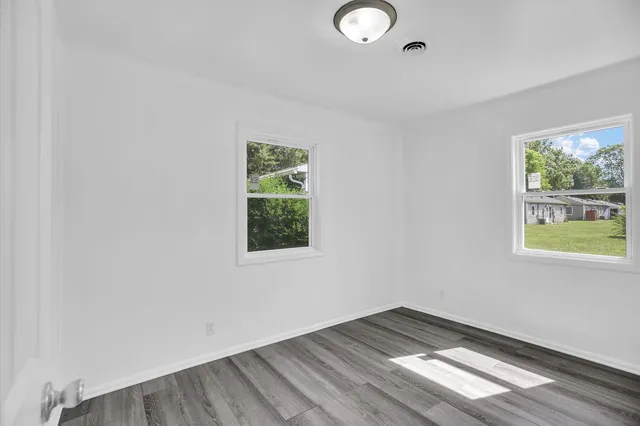 a view of an empty room and wooden floor