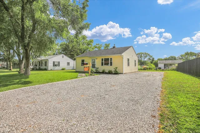 a view of house with backyard and garden