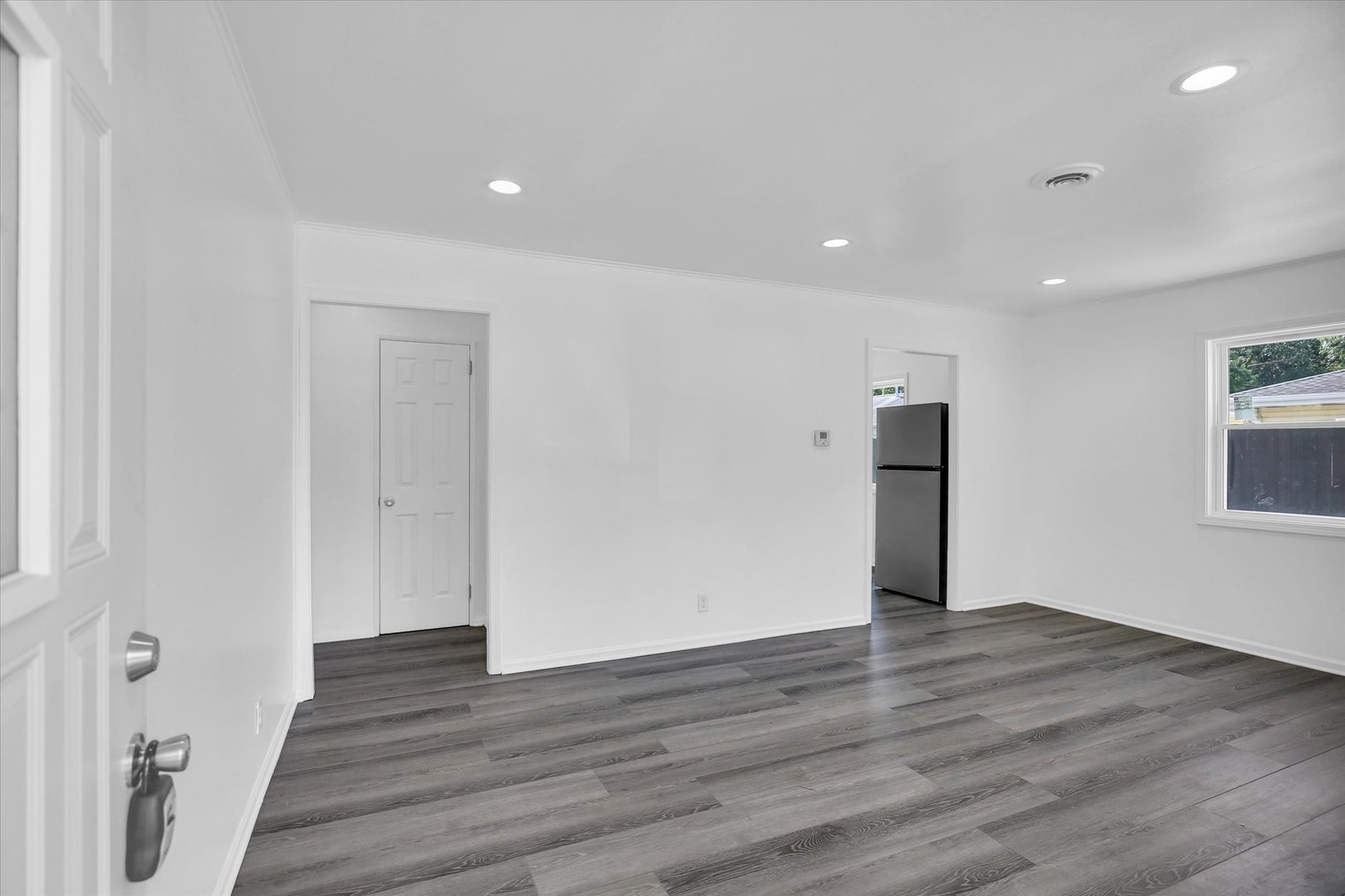 804 Juniper Drive Rantoul, IL 61866 - Photo 5 of 24 a view of an empty room with wooden floor