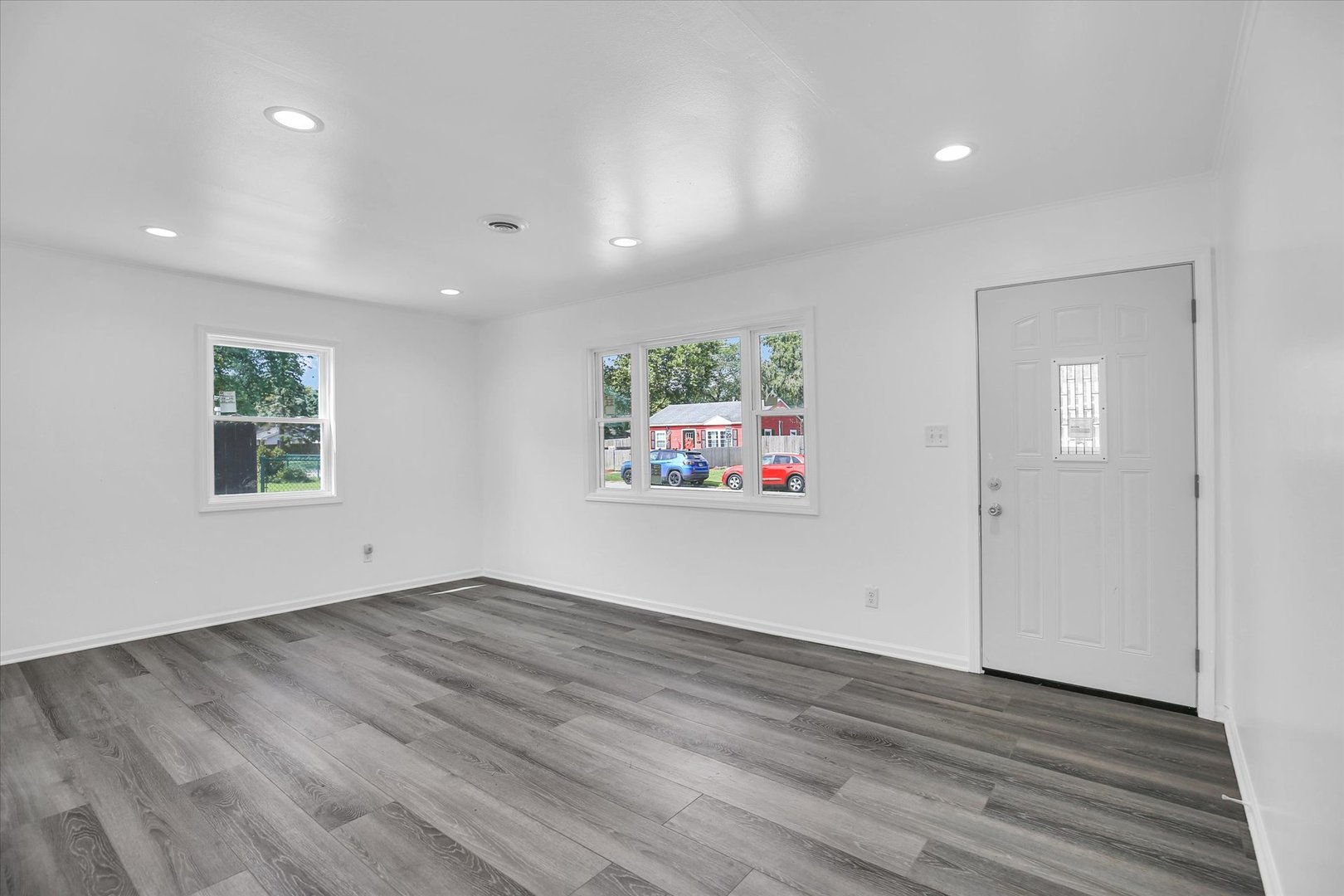 804 Juniper Drive Rantoul, IL 61866 - Photo 6 of 24 an empty room with wooden floor and window
