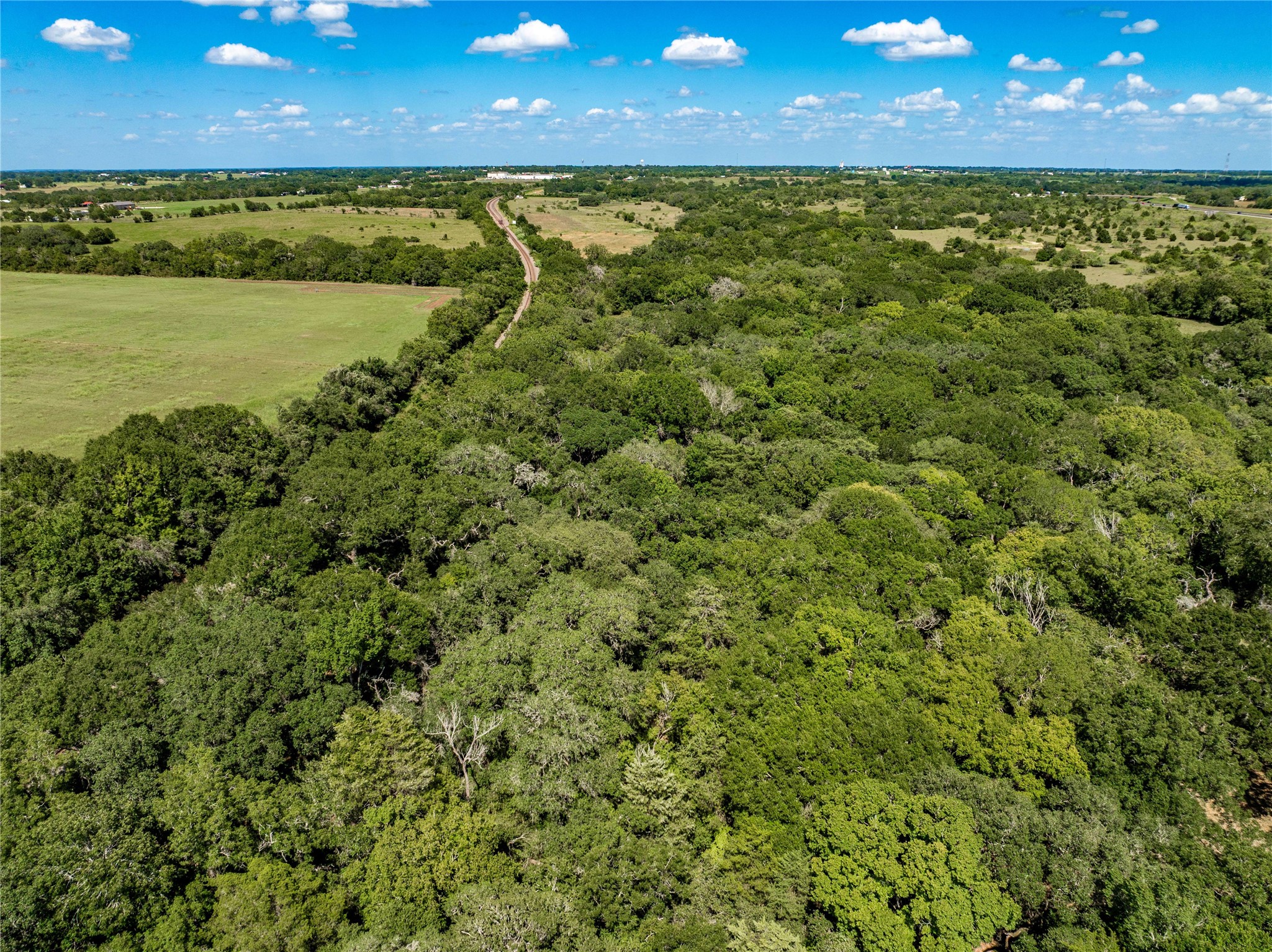 253 Cr 253 Road Weimar, TX 78962 - Photo 7 of 27 a view of a yard with a table and chairs under an umbrella