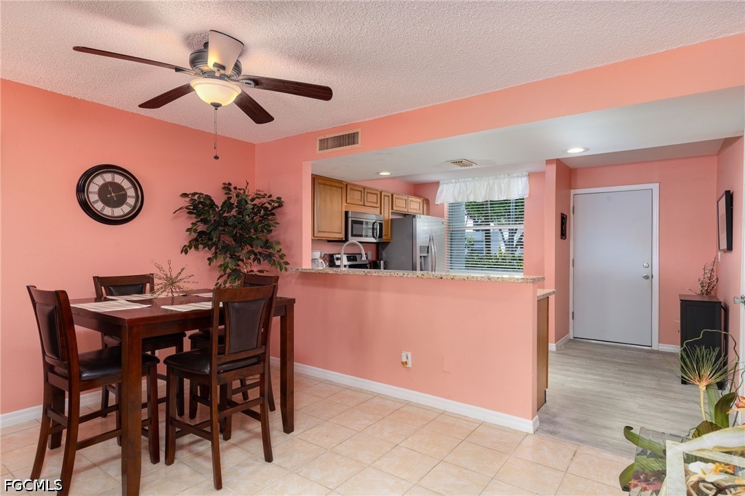 5959 Winkler Road, Unit 103 Fort Myers, FL 33919 - Photo 13 of 24 a view of a dining room and a table and chairs