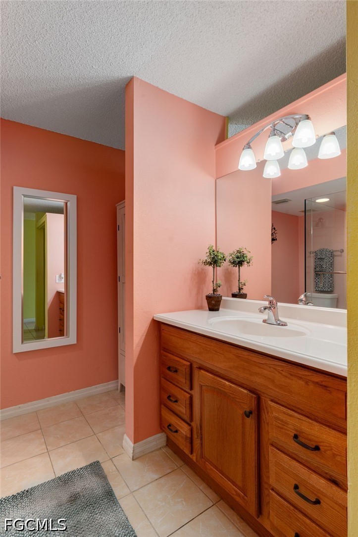 5959 Winkler Road, Unit 103 Fort Myers, FL 33919 - Photo 16 of 24 a bathroom with a double vanity sink and a mirror
