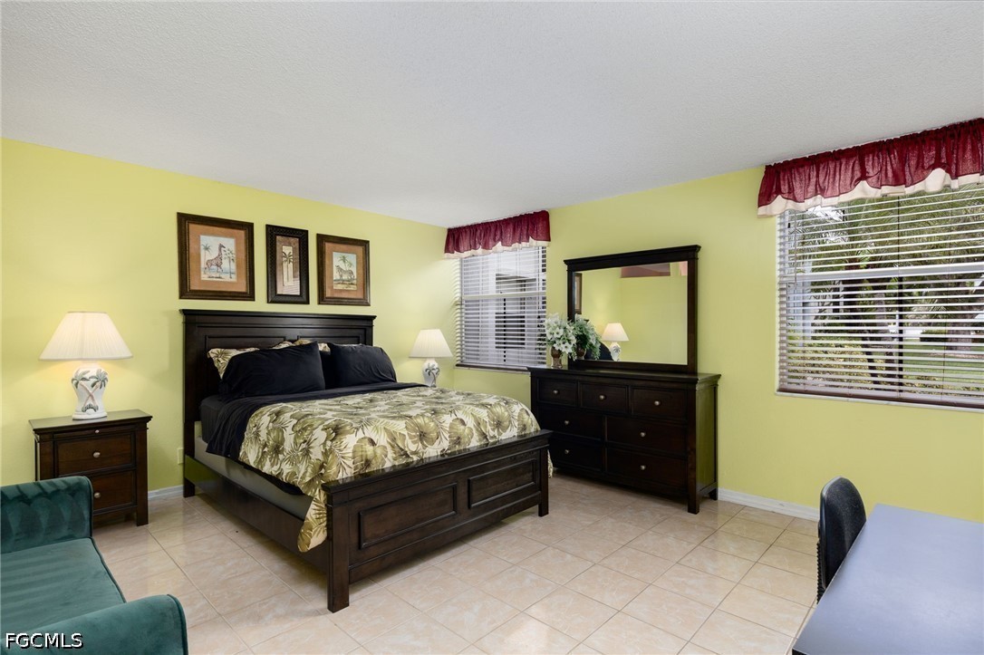 5959 Winkler Road, Unit 103 Fort Myers, FL 33919 - Photo 17 of 24 a bedroom with a bed and wooden floor