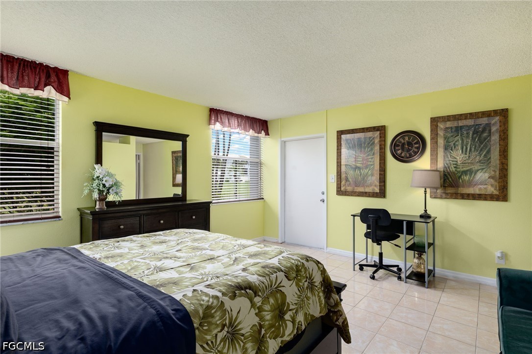 5959 Winkler Road, Unit 103 Fort Myers, FL 33919 - Photo 18 of 24 a bedroom with a bed and a table in it