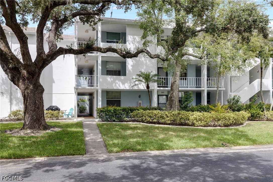 5959 Winkler Road, Unit 103 Fort Myers, FL 33919 - Photo 2 of 24 a front view of a house with a garden