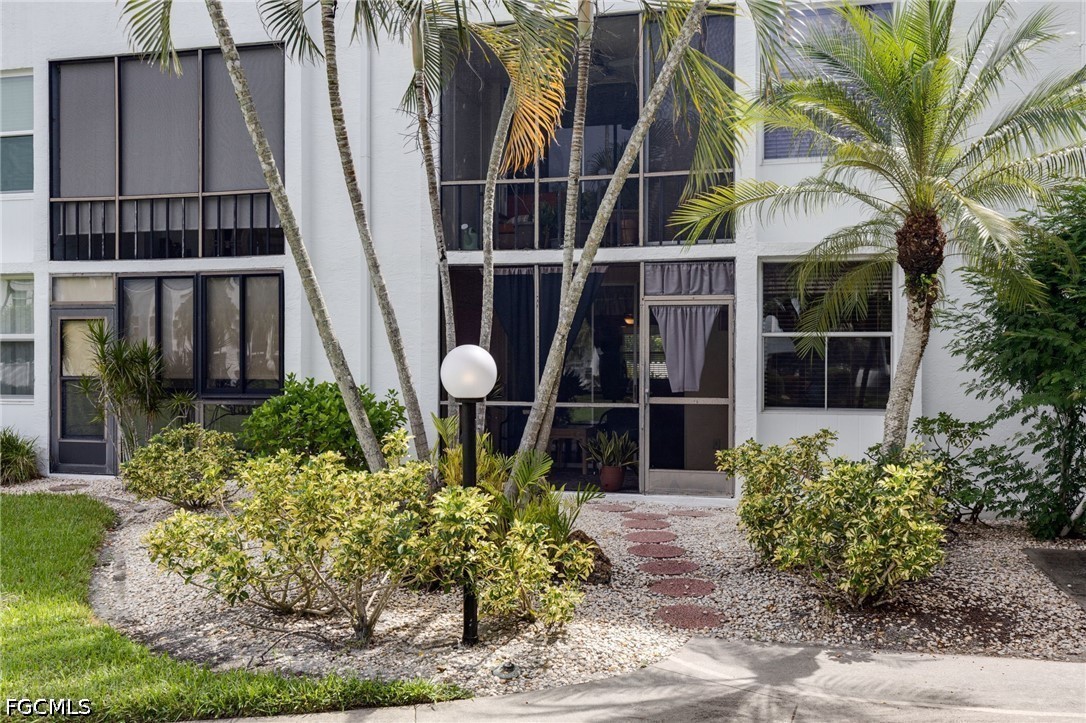 5959 Winkler Road, Unit 103 Fort Myers, FL 33919 - Photo 4 of 24 a front view of a house with a garden