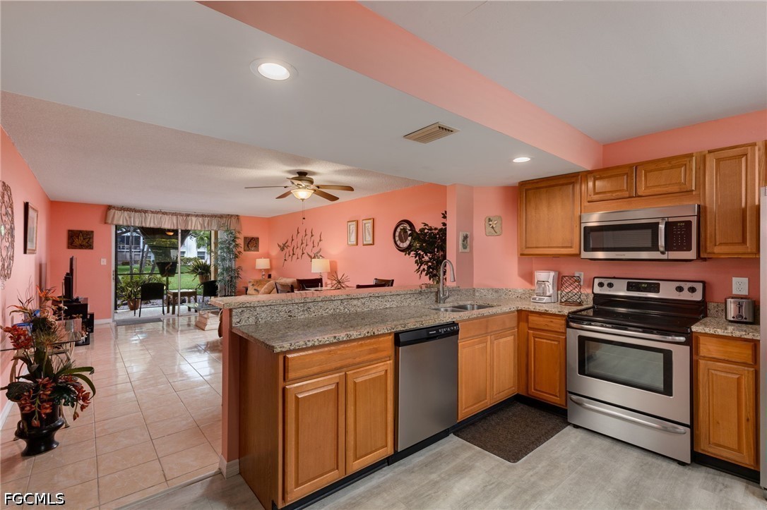 5959 Winkler Road, Unit 103 Fort Myers, FL 33919 - Photo 6 of 24 a kitchen with stainless steel appliances granite countertop a stove and a sink