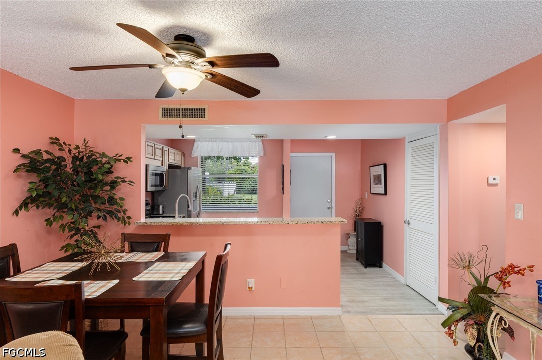 5959 Winkler Road, Unit 103 Fort Myers, FL 33919 - Photo 9 of 24 a view of a livingroom with furniture and a ceiling fan