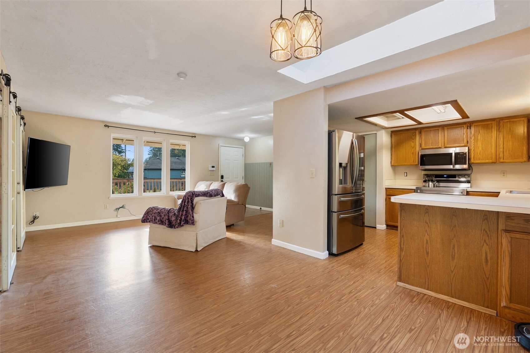 1003 Northwest Dexter Avenue Winlock, WA 98596 - Photo 15 of 39 a kitchen with stainless steel appliances wooden floor and refrigerator