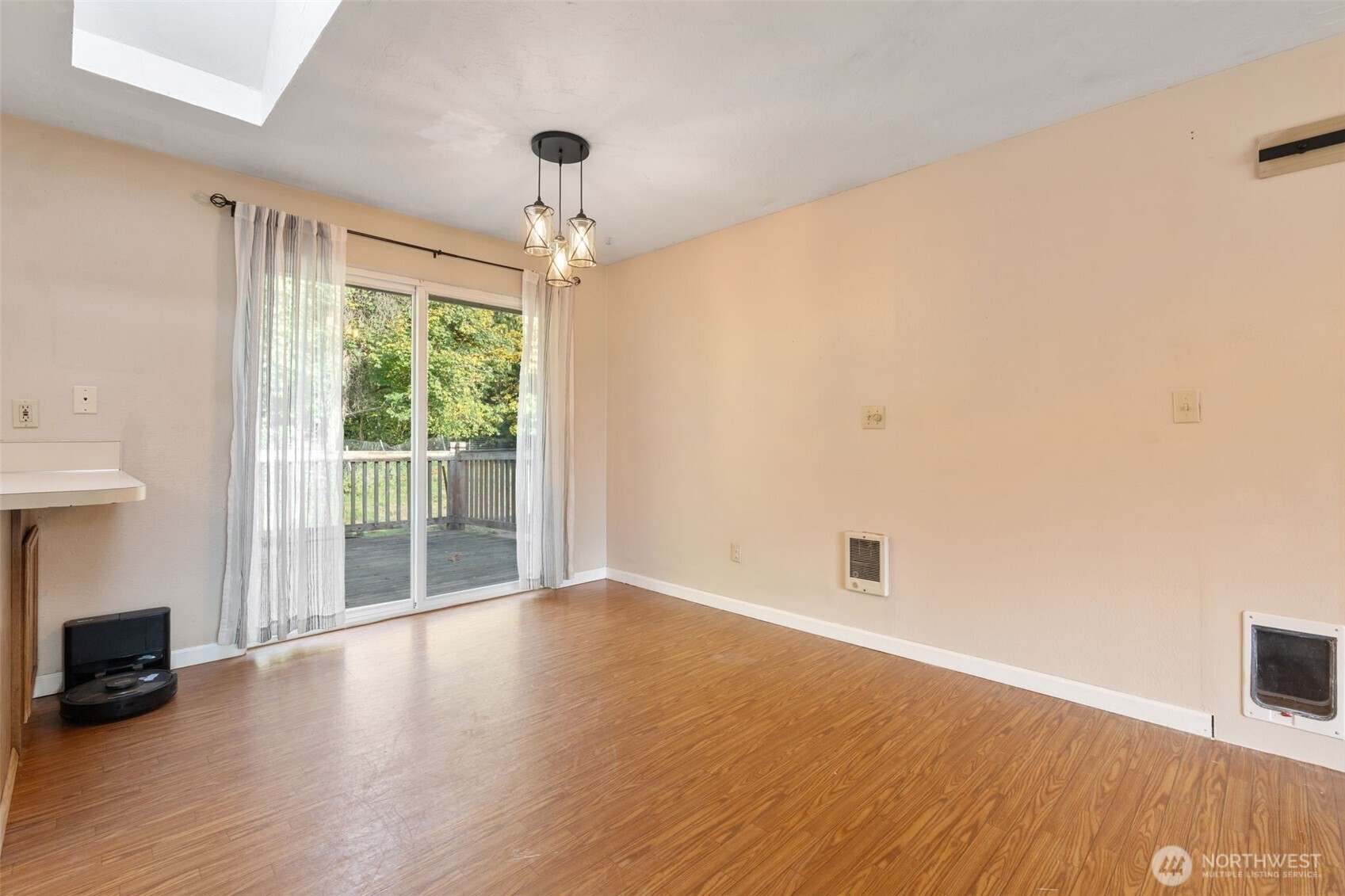 1003 Northwest Dexter Avenue Winlock, WA 98596 - Photo 16 of 39 an empty room with wooden floor and windows