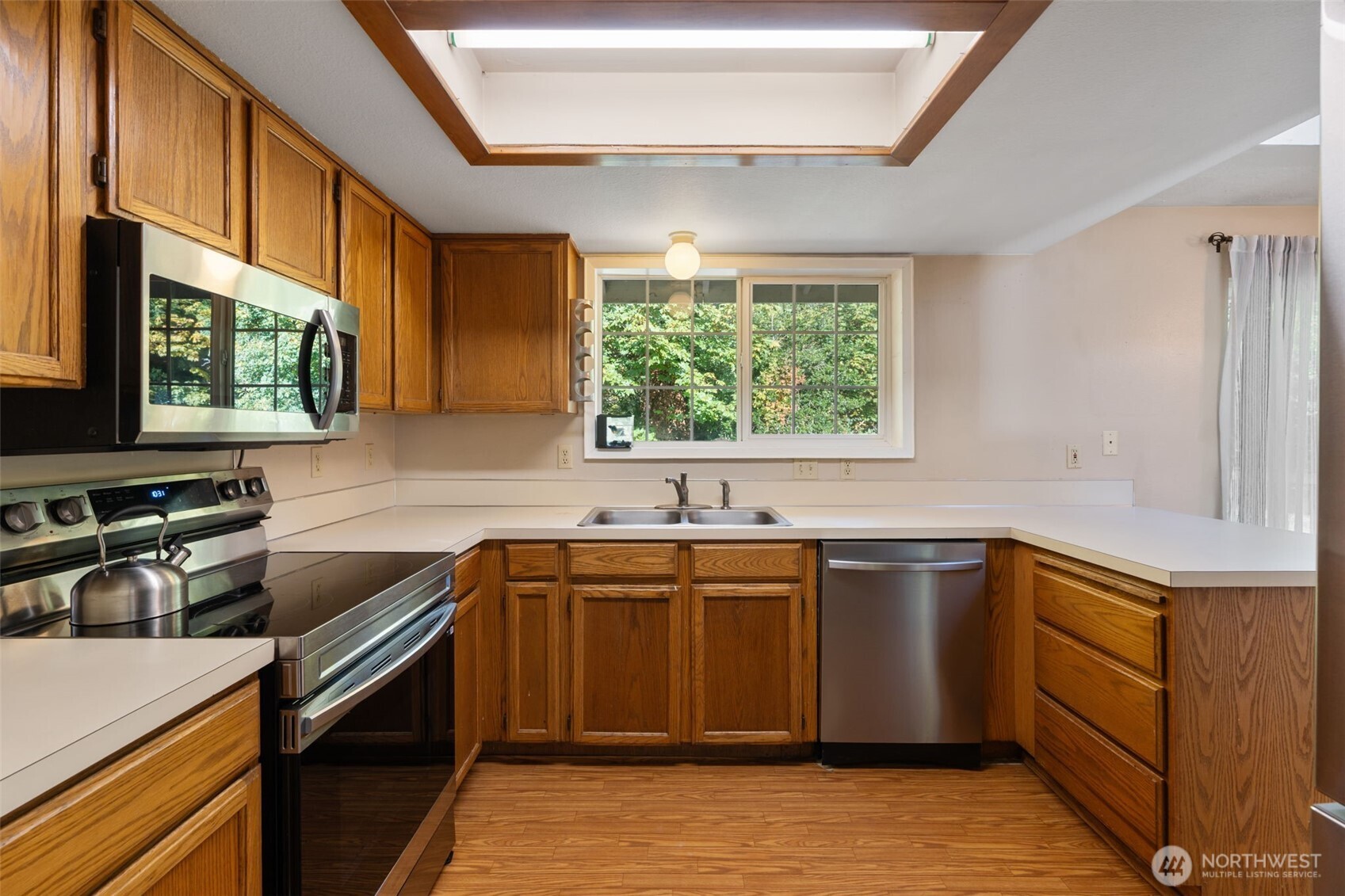 1003 Northwest Dexter Avenue Winlock, WA 98596 - Photo 17 of 39 a kitchen with stainless steel appliances granite countertop a sink stove and cabinets