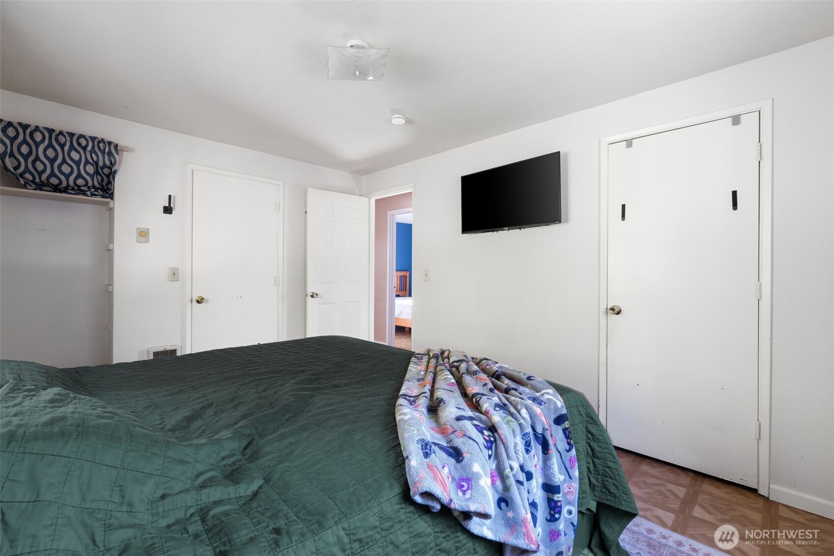 1003 Northwest Dexter Avenue Winlock, WA 98596 - Photo 21 of 39 a bedroom with a large bed and a flat screen tv