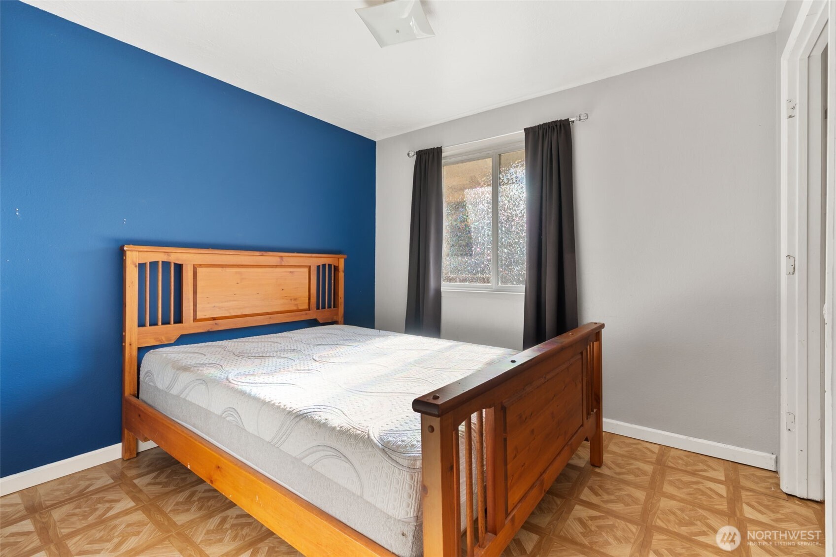 1003 Northwest Dexter Avenue Winlock, WA 98596 - Photo 23 of 39 a bed sitting in a bedroom next to a window