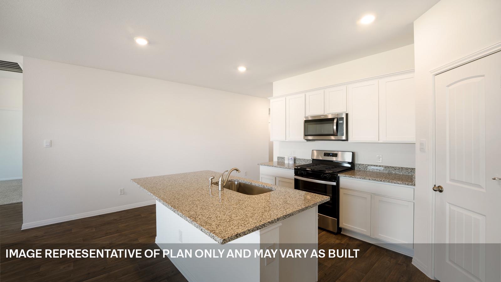 185 Mountain Pea Road Kyle, TX 78640 - Photo 5 of 22 a kitchen with sink cabinets and microwave