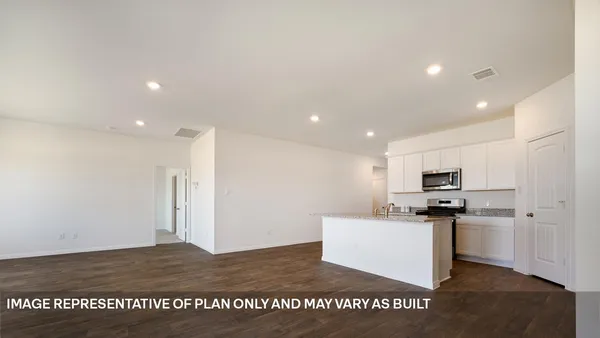 a kitchen with stainless steel appliances kitchen island granite countertop a refrigerator sink and microwave