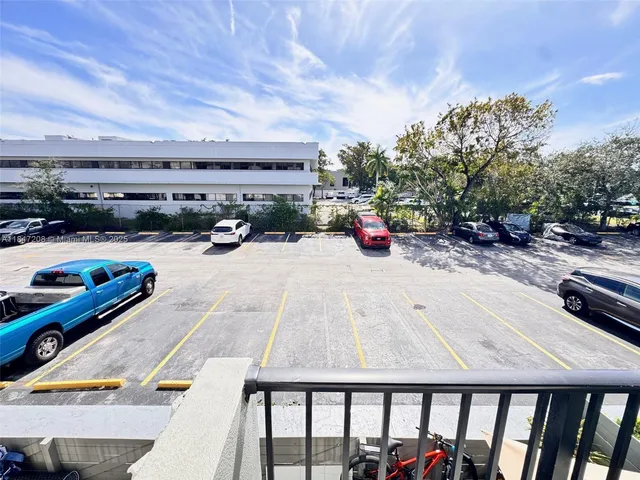 a view of a balcony with car parked