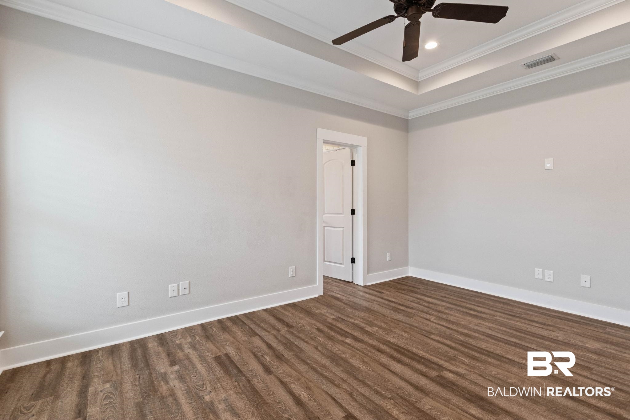 17376 Bankhead Boulevard Fairhope, AL 36532 - Photo 37 of 73 Unfurnished room with a raised ceiling, crown molding, dark wood-type flooring, and ceiling fan