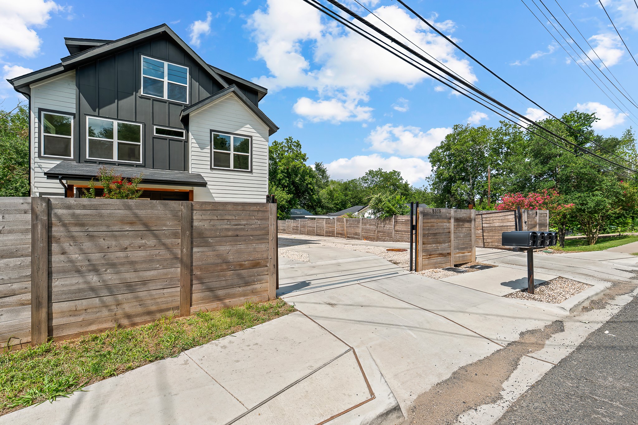 5305 Ledesma Road, Unit 4 Austin, TX 78721 - Photo 35 of 40 Modern façade with a private entry, showcasing crisp lines and a wood fence.
