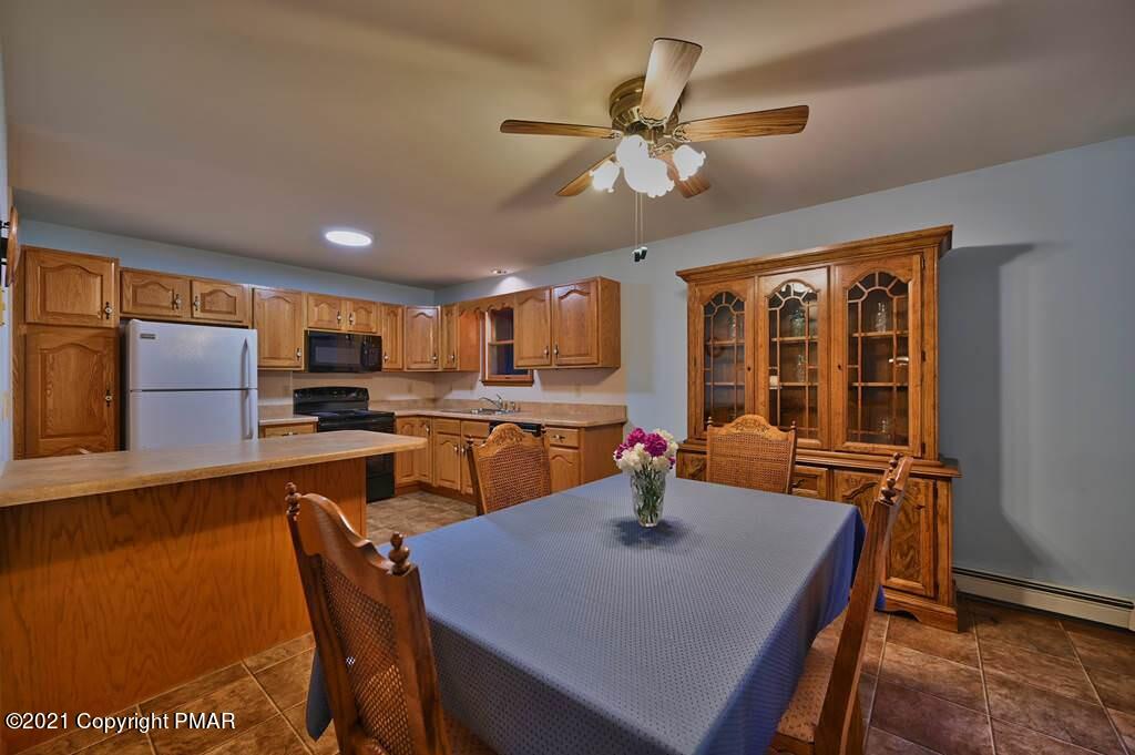 168 Shenkel Road Effort, PA 18330 - Photo 16 of 64 a kitchen with a table chairs and microwave