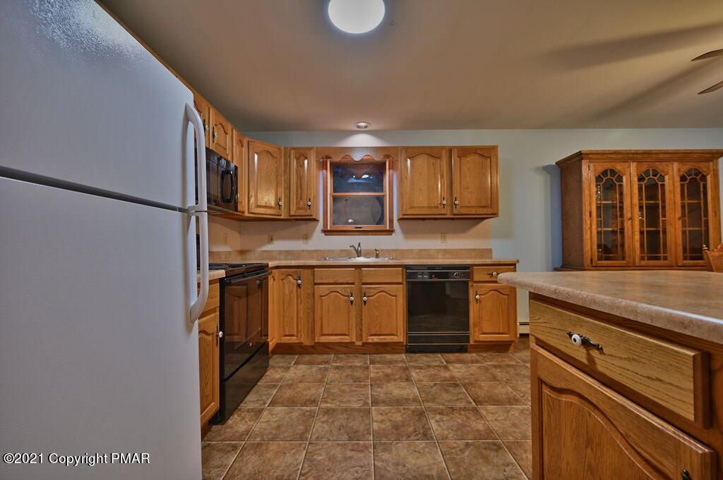 168 Shenkel Road Effort, PA 18330 - Photo 18 of 64 a kitchen with stainless steel appliances granite countertop a stove a sink and a microwave