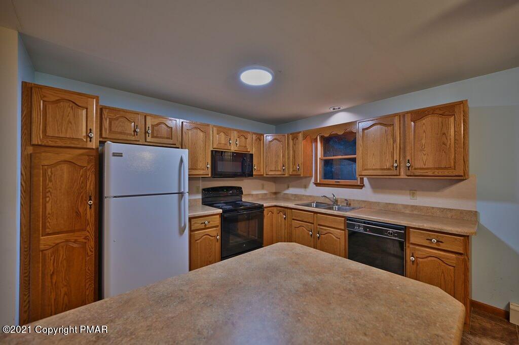 168 Shenkel Road Effort, PA 18330 - Photo 19 of 64 a kitchen with stainless steel appliances granite countertop a refrigerator stove microwave and sink