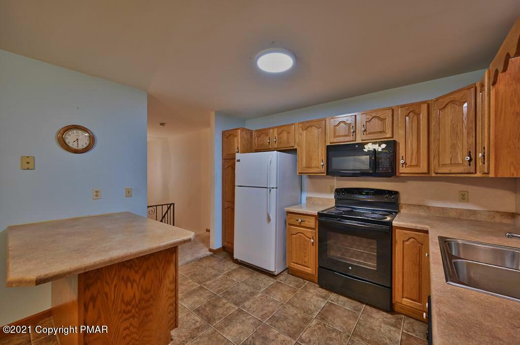 168 Shenkel Road Effort, PA 18330 - Photo 20 of 64 a kitchen with stainless steel appliances a stove microwave and refrigerator