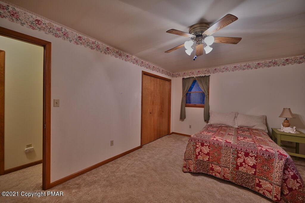 168 Shenkel Road Effort, PA 18330 - Photo 23 of 64 a bedroom with a bed and a chandelier