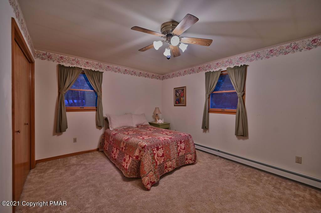 168 Shenkel Road Effort, PA 18330 - Photo 25 of 64 a bedroom with a bed and a painting on the wall