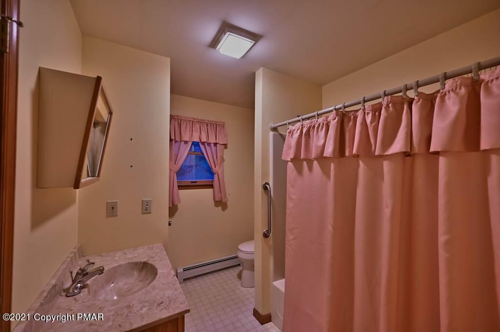 168 Shenkel Road Effort, PA 18330 - Photo 29 of 64 a bathroom with a shower curtain and a toilet