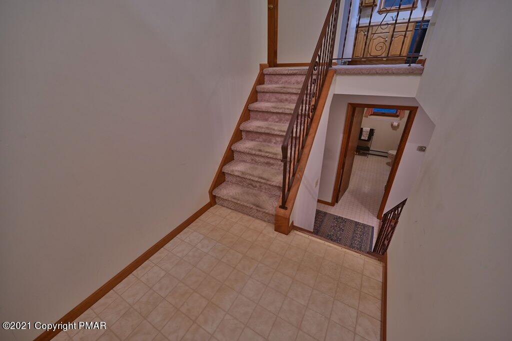 168 Shenkel Road Effort, PA 18330 - Photo 37 of 64 a view of staircase with wooden floor and white walls