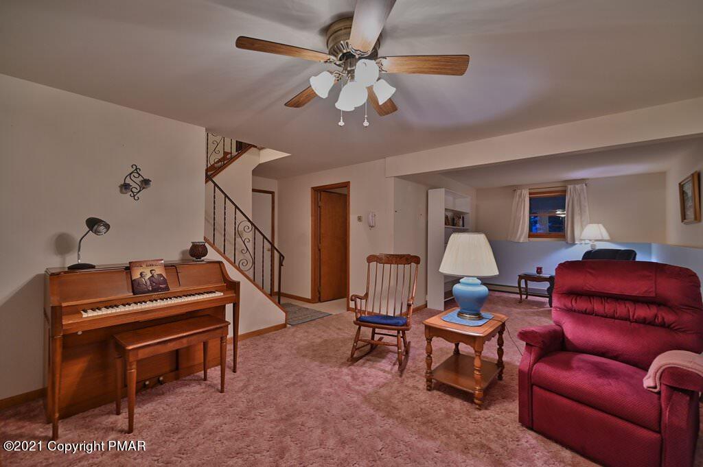 168 Shenkel Road Effort, PA 18330 - Photo 40 of 64 a living room with furniture a piano and a chandelier