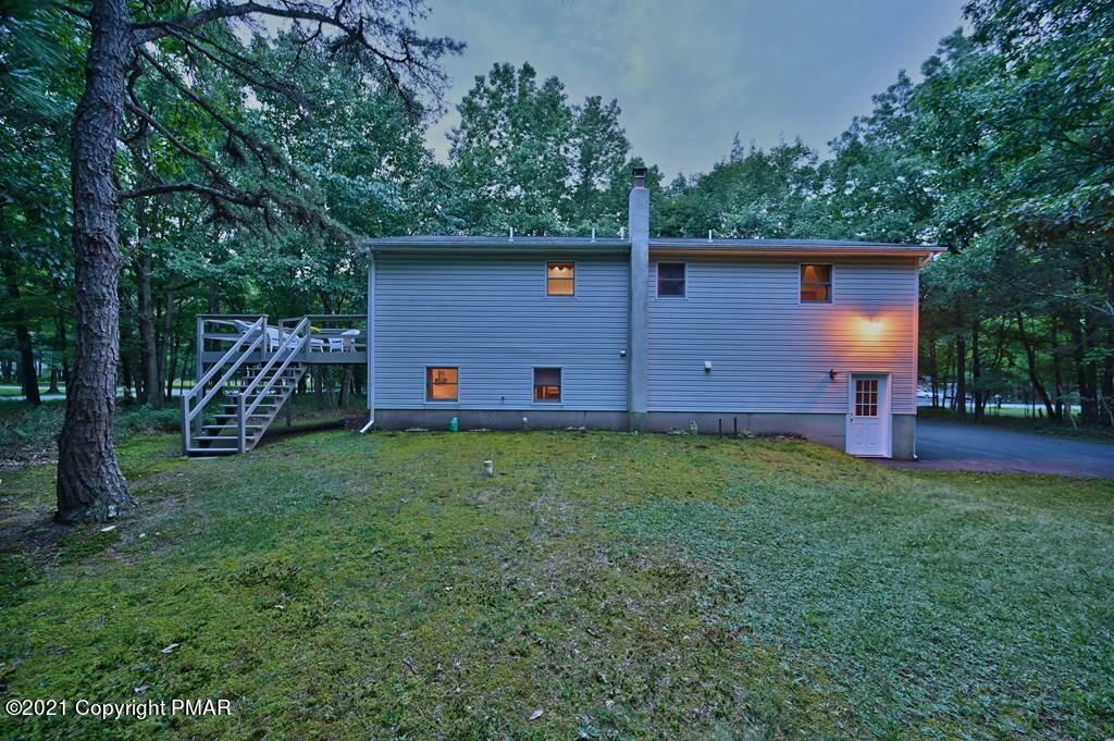 168 Shenkel Road Effort, PA 18330 - Photo 60 of 64 a view of backyard of house with wooden fence and trees