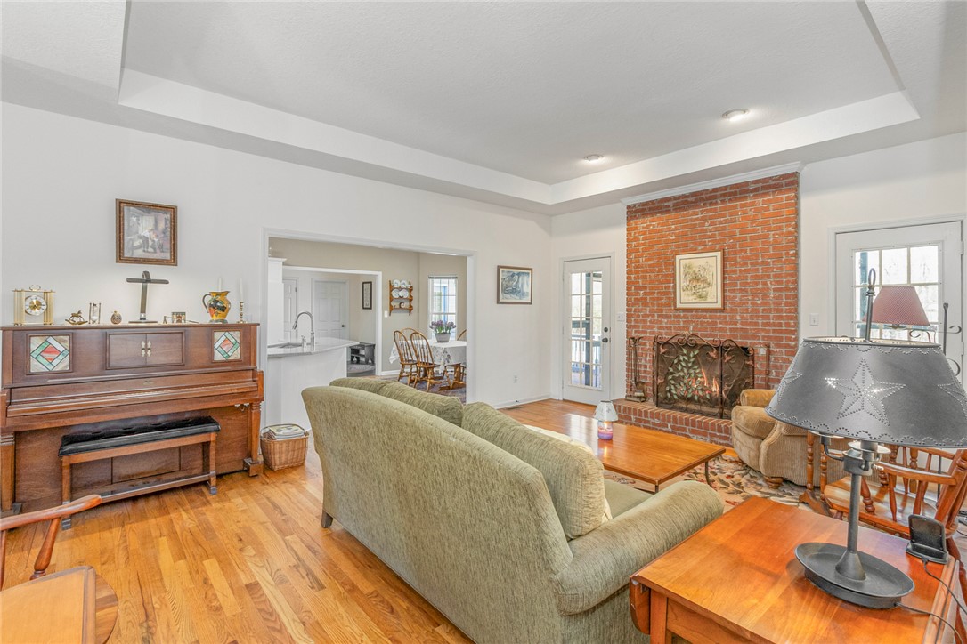 108 Pearman Drive Pendleton, SC 29670 - Photo 6 of 50 This living room features gleaming hardwood floors and a striking brick fireplace.