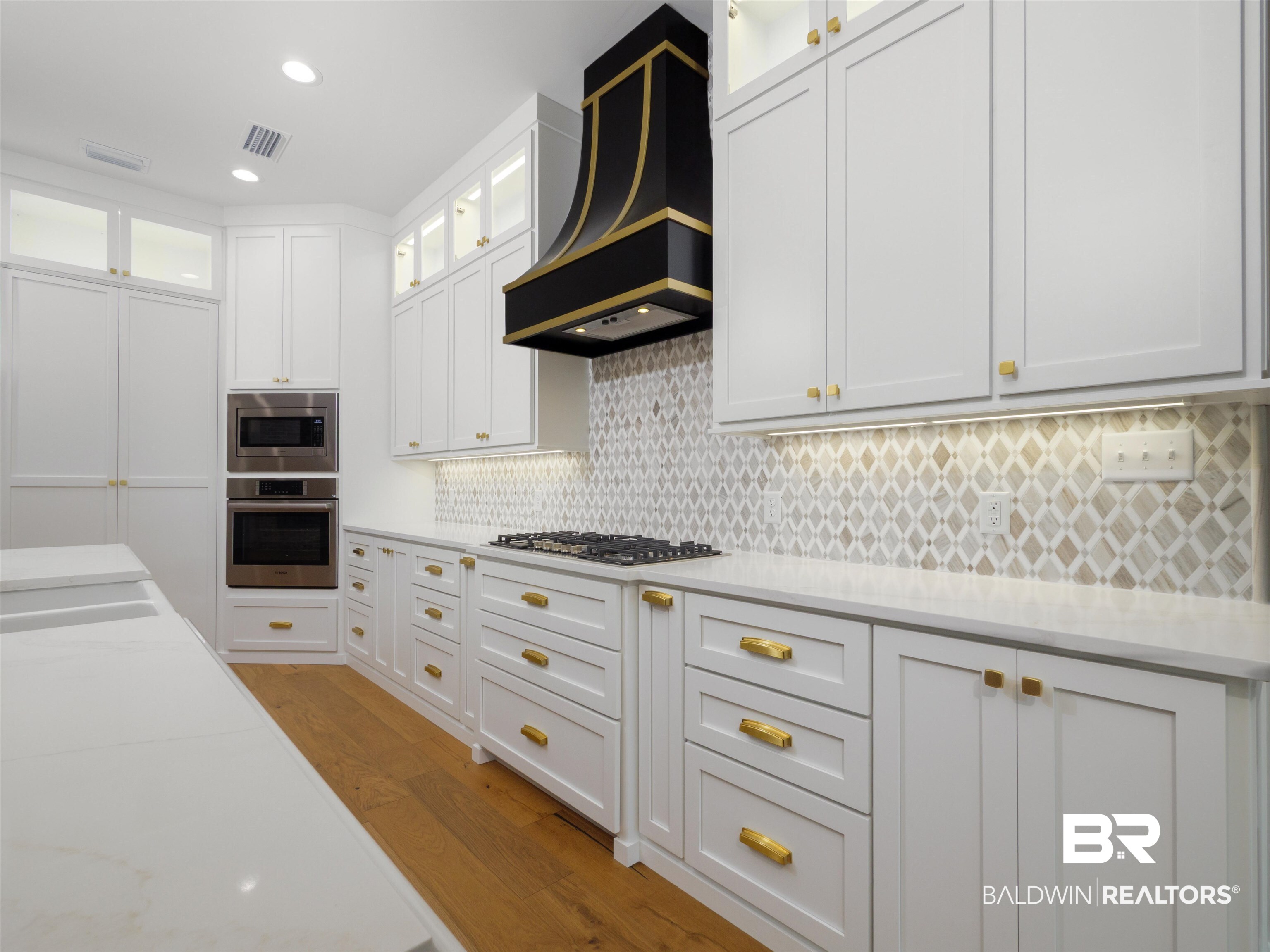 10912 Catania Avenue Fairhope, AL 36532 - Photo 13 of 54 View of the kitchen with a custom hood vent