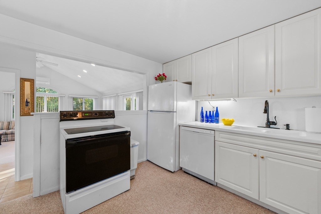 28 Robinson Road Woburn, MA 01801 - Photo 17 of 42 a kitchen with stainless steel appliances granite countertop a refrigerator sink and cabinets
