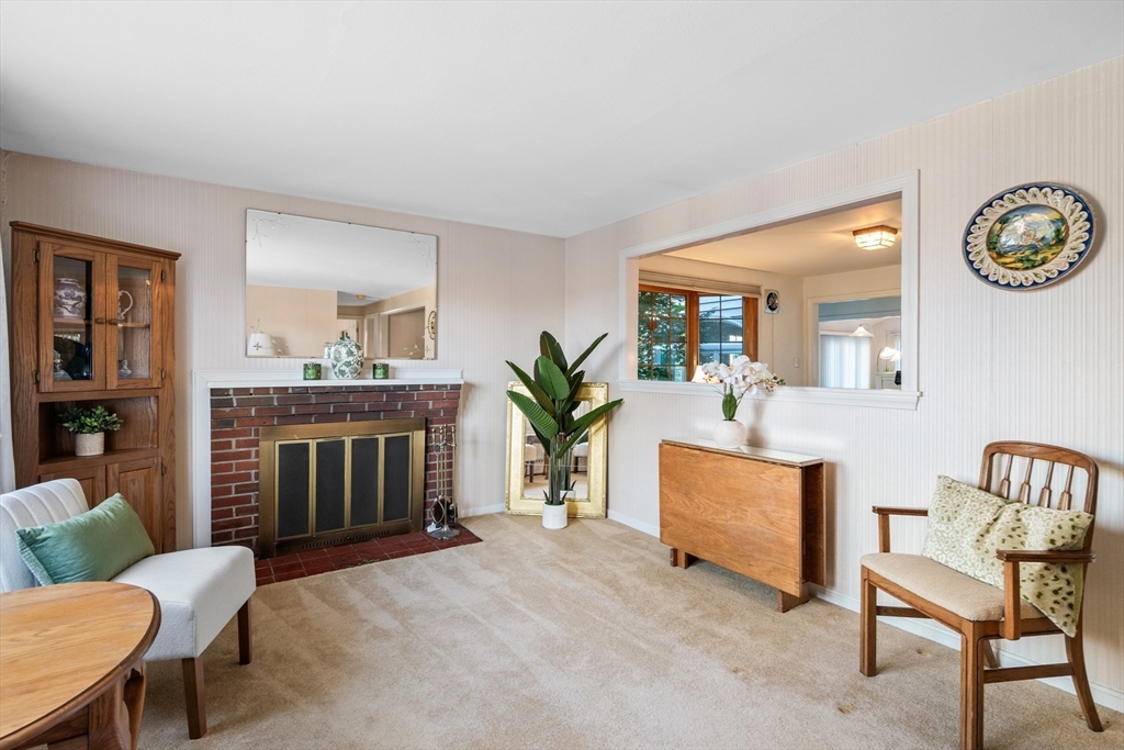 28 Robinson Road Woburn, MA 01801 - Photo 26 of 42 a living room with furniture a fireplace and a window