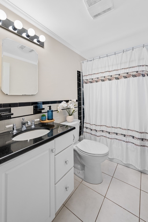 28 Robinson Road Woburn, MA 01801 - Photo 33 of 42 a bathroom with a granite countertop sink mirror vanity and toilet
