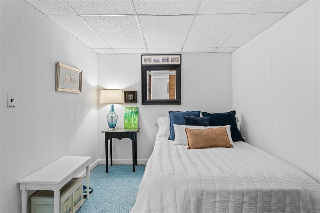 28 Robinson Road Woburn, MA 01801 - Photo 39 of 42 a bedroom with a bed and a table in it