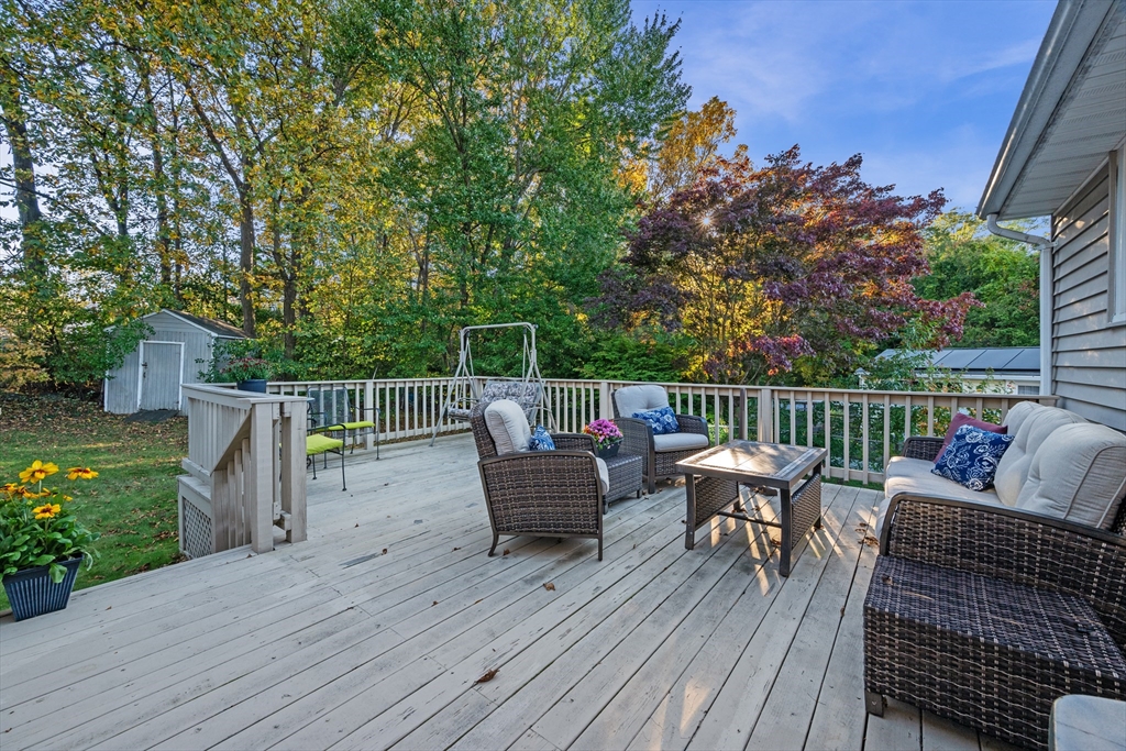 28 Robinson Road Woburn, MA 01801 - Photo 6 of 42 a view of a deck with furniture and trees in the background
