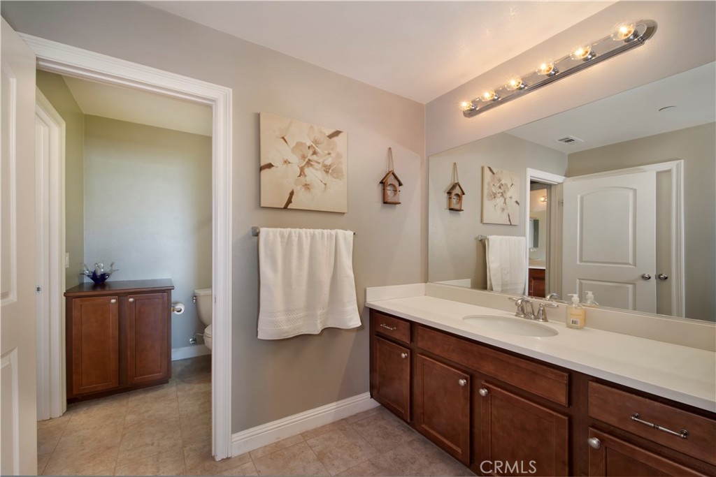 5572 Thoroughbred Street Oceanside, CA 92057 - Photo 16 of 38 a bathroom with a sink double vanity and a mirror