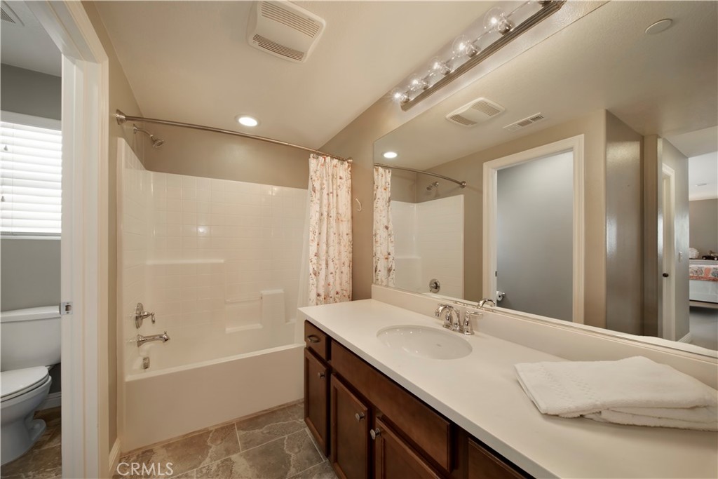 5572 Thoroughbred Street Oceanside, CA 92057 - Photo 17 of 38 a bathroom with a bathtub double vanity sink and a mirror