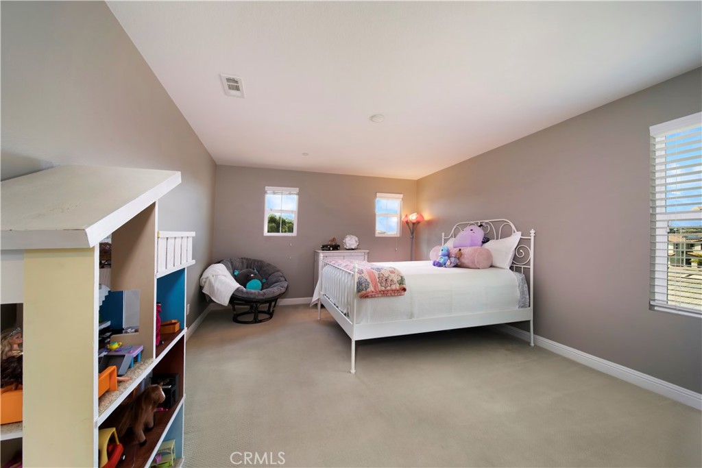 5572 Thoroughbred Street Oceanside, CA 92057 - Photo 18 of 38 a bed room with a bed and a window