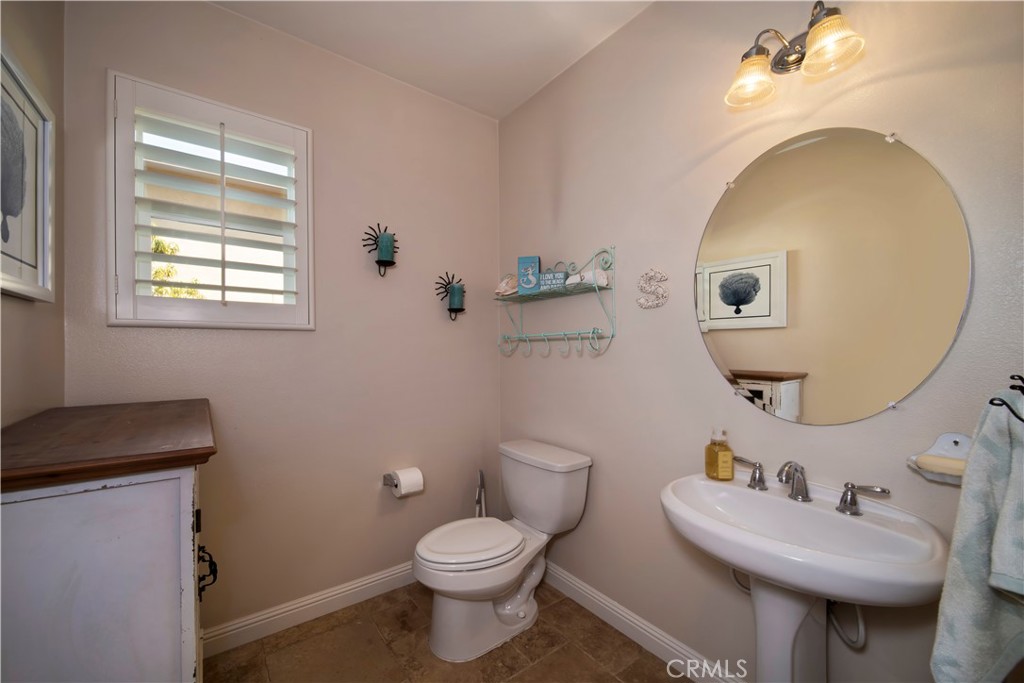 5572 Thoroughbred Street Oceanside, CA 92057 - Photo 19 of 38 a bathroom with a toilet sink and mirror