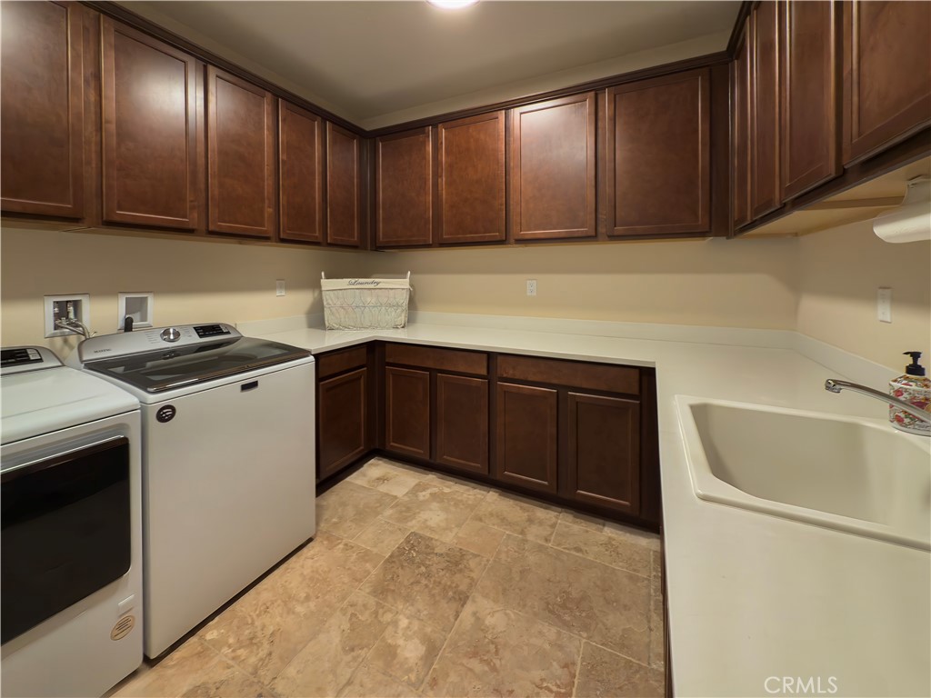5572 Thoroughbred Street Oceanside, CA 92057 - Photo 20 of 38 a kitchen with a sink a stove and cabinets