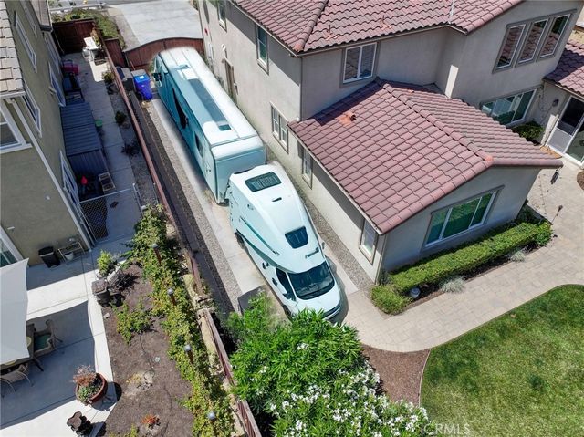 a view of a patio with table and chairs under an umbrella