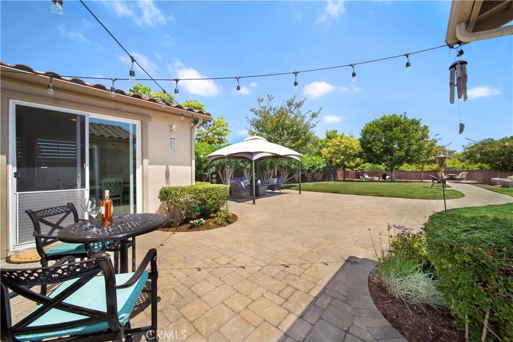 5572 Thoroughbred Street Oceanside, CA 92057 - Photo 24 of 38 a view of a patio with table and chairs under an umbrella