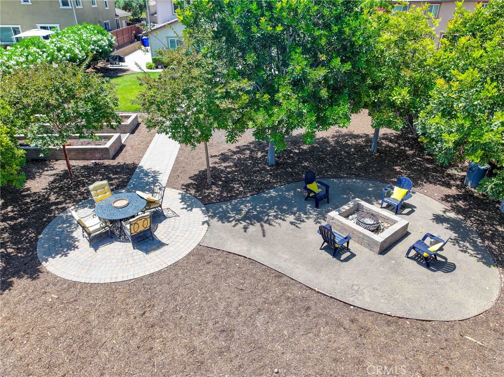 5572 Thoroughbred Street Oceanside, CA 92057 - Photo 26 of 38 a backyard of a house with fireplace table and chairs